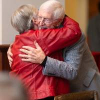 Two event attendees hugging